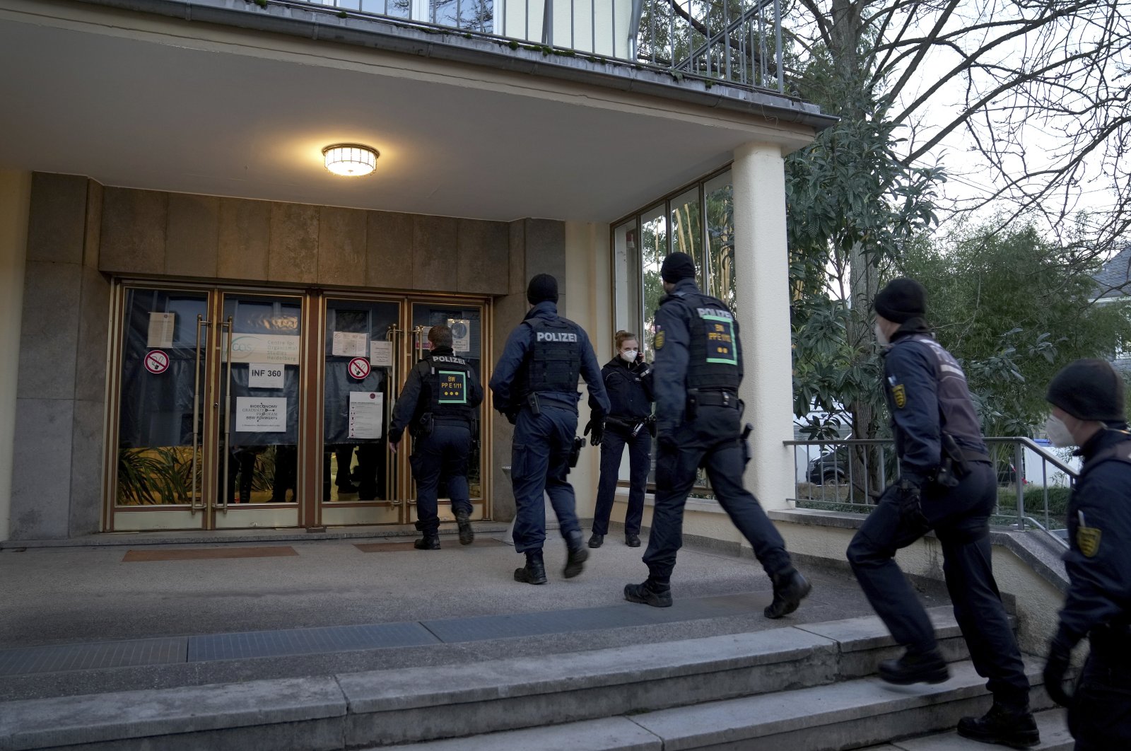 Police officers enter the crime scene on the grounds of the Heidelberg University in Heidelberg, Germany, Jan. 24, 2022. (AP Photo)