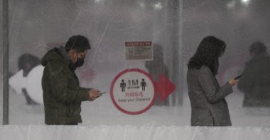 People queue in line for a COVID-19 test while maintaining social distancing at a temporary screening clinic for the coronavirus in Seoul, South Korea, Jan. 25, 2022. (AP Photo)