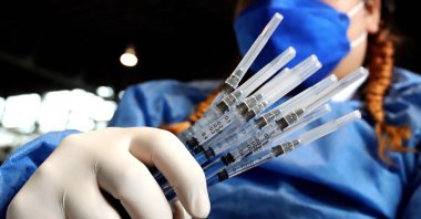 A nurse prepares booster doses of AstraZeneca's COVID-19 vaccine for people over 50 at a vaccination center set up at the Benito Juarez Auditorium in Zapopan, state of Jalisco, Mexico, Jan. 24, 2022. (AFP Photo)