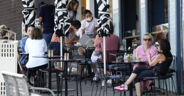 Customers sit outside a cafe at Bondi Beach in Sydney, Australia, Jan. 8, 2022. (AP Photo)