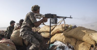 A Yemeni fighter backed by the Saudi-led coalition fires his weapon during clashes with Houthi rebels on the Kassara frontline near Marib, Yemen, June 20, 2021. (AP Photo)