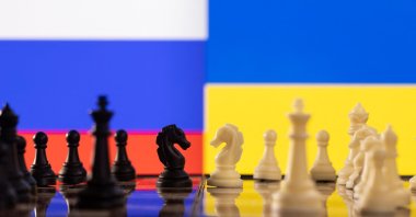Chess pieces are seen in front of displayed Russia and Ukraine's flags, Jan. 25, 2022. (Reuters Photo)
