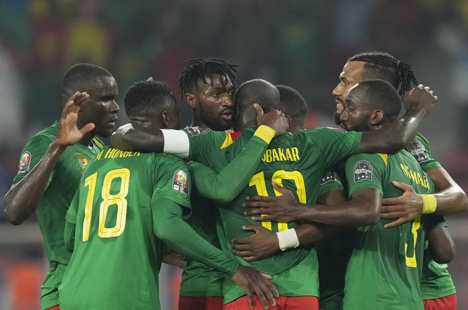 Cameroon&#039;s Karl Toko-Ekambi (C) celebrates with teammates after scoring in an AFCON match against Comoros, Yaounde, Cameroon, Jan. 24, 2022. (AP Photo)