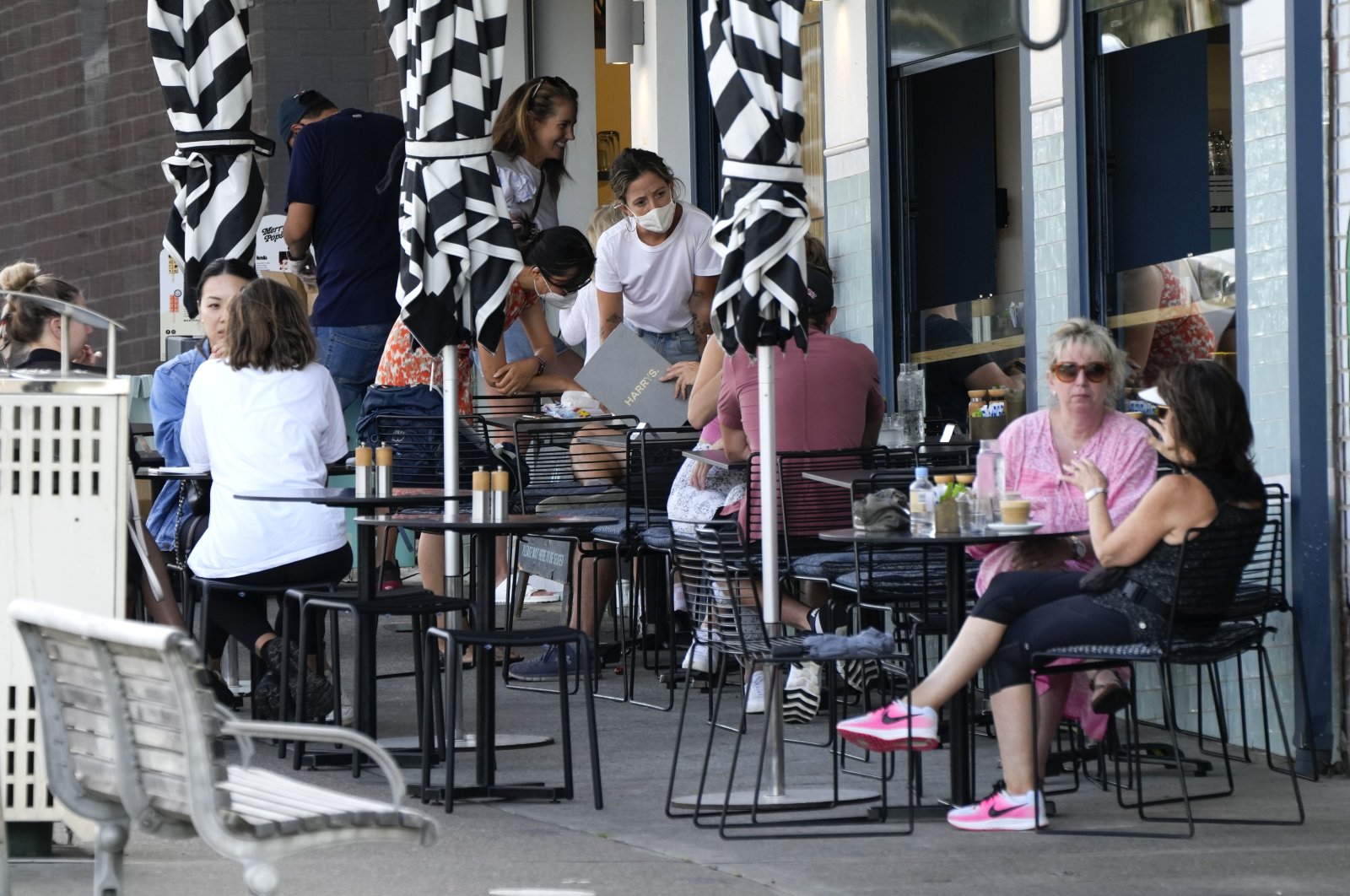 Customers sit outside a cafe at Bondi Beach in Sydney, Australia, Jan. 8, 2022. (AP Photo)