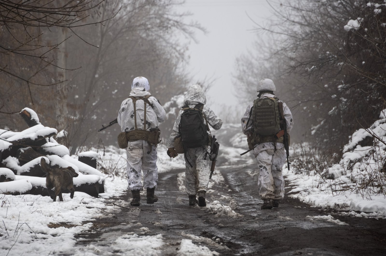 Ukrainian soldiers walk at the line of separation from pro-Russian rebels near Katerinivka, Donetsk region, Ukraine, Dec. 7, 2021. (AP Photo)