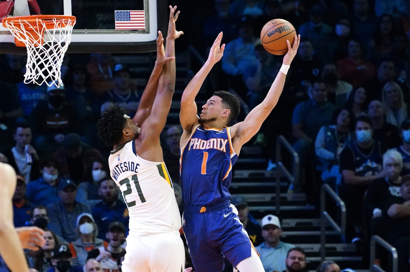 Phoenix Suns Devin Booker (R) shoots as Utah Jazz center Hassan Whiteside (L) defends during an NBA game, Phoenix, Arizona, U.S., Jan. 24, 2022. (AP Photo)