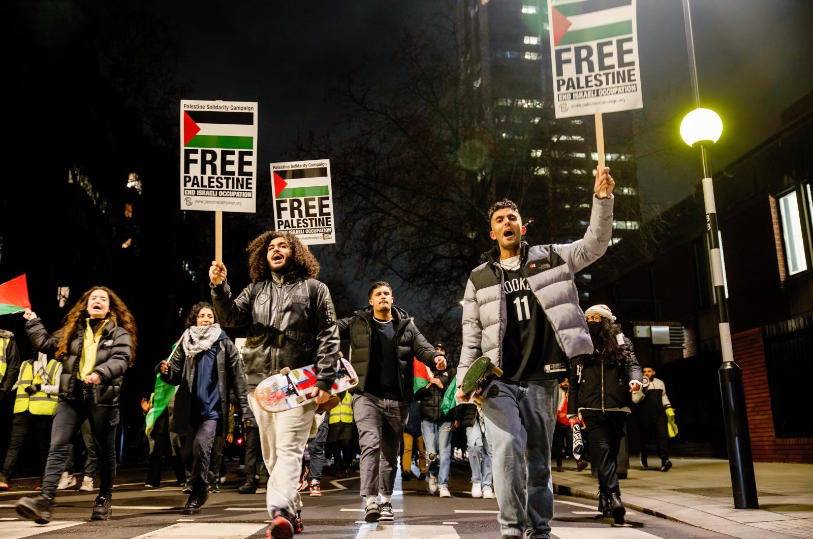 Demonstrators march  with placards that read &quot;Free Palestine&quot; during the demonstration, London, the U.K., Jan. 19, 2022. (Reuters Photo)