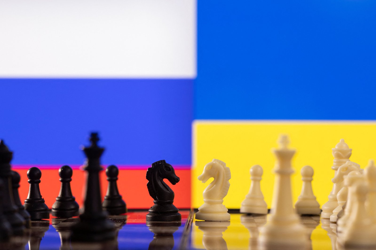 Chess pieces are seen in front of displayed Russia and Ukraine&#039;s flags, Jan. 25, 2022. (Reuters Photo)