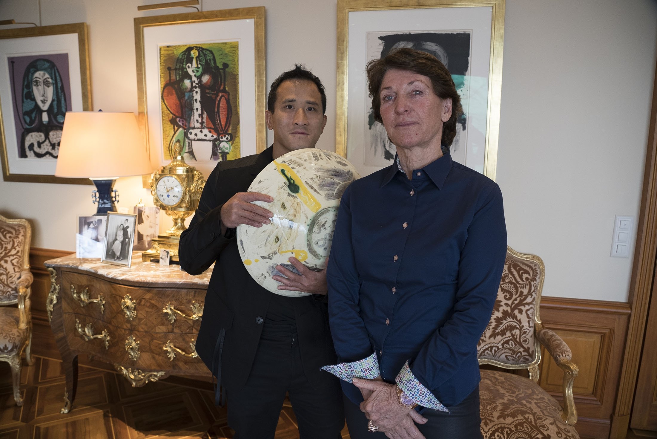 Marina Picasso (R), granddaughter of artist Pablo Picasso, and her son Florian Picasso pose with a ceramic art-work of Pablo Picasso in Cologny near in Geneva, Switzerland, Jan. 25, 2022. (AP Photo)