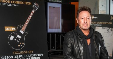 Artist/musician Julian Lennon poses in front of the NFT part of the "Lennon Connection: The NFT Collection" auction featuring cherished Beatles and John Lennon memorabilia from his private collection, at Julien's Auctions, in Beverly Hills, California, Jan. 25, 2022. (AFP Photo)