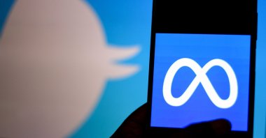 In this photo illustration a metaverse logo is seen on a smartphone with a Twitter logo in the background. (Reuters Photo)