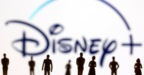Toy figures of people are seen in front of the displayed Disney  logo, Jan. 20, 2022. (Reuters Photo)