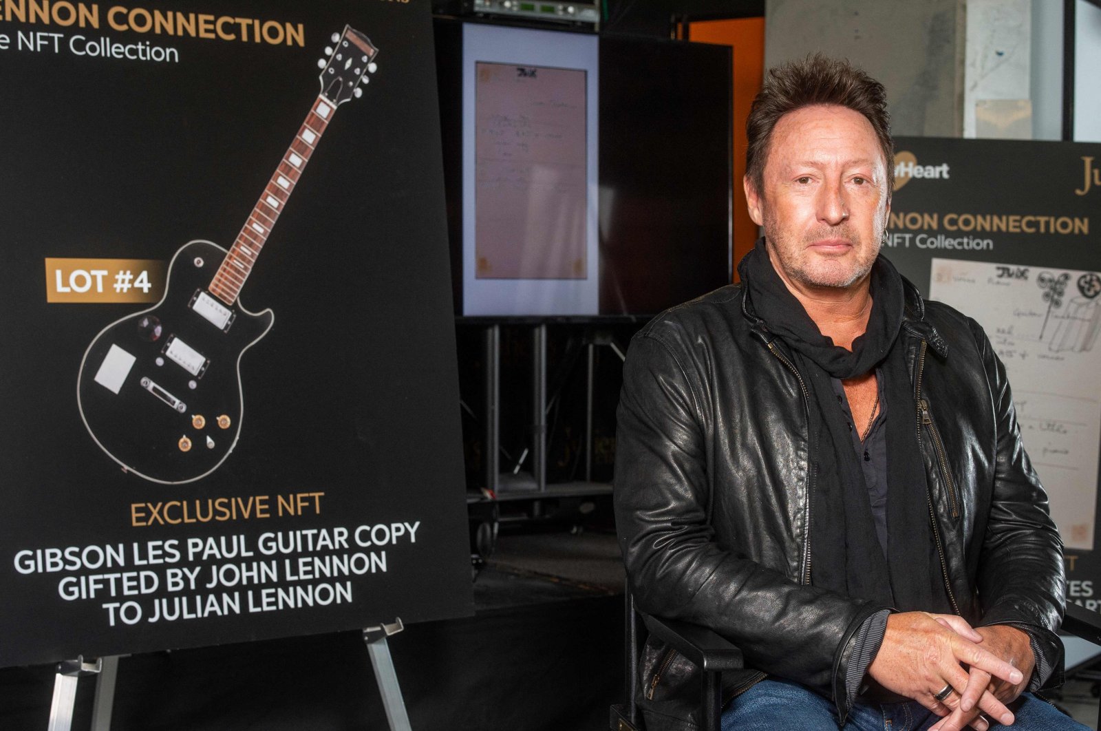 Artist/musician Julian Lennon poses in front of the NFT part of the &quot;Lennon Connection: The NFT Collection&quot; auction featuring cherished Beatles and John Lennon memorabilia from his private collection, at Julien&#039;s Auctions, in Beverly Hills, California, Jan. 25, 2022. (AFP Photo)