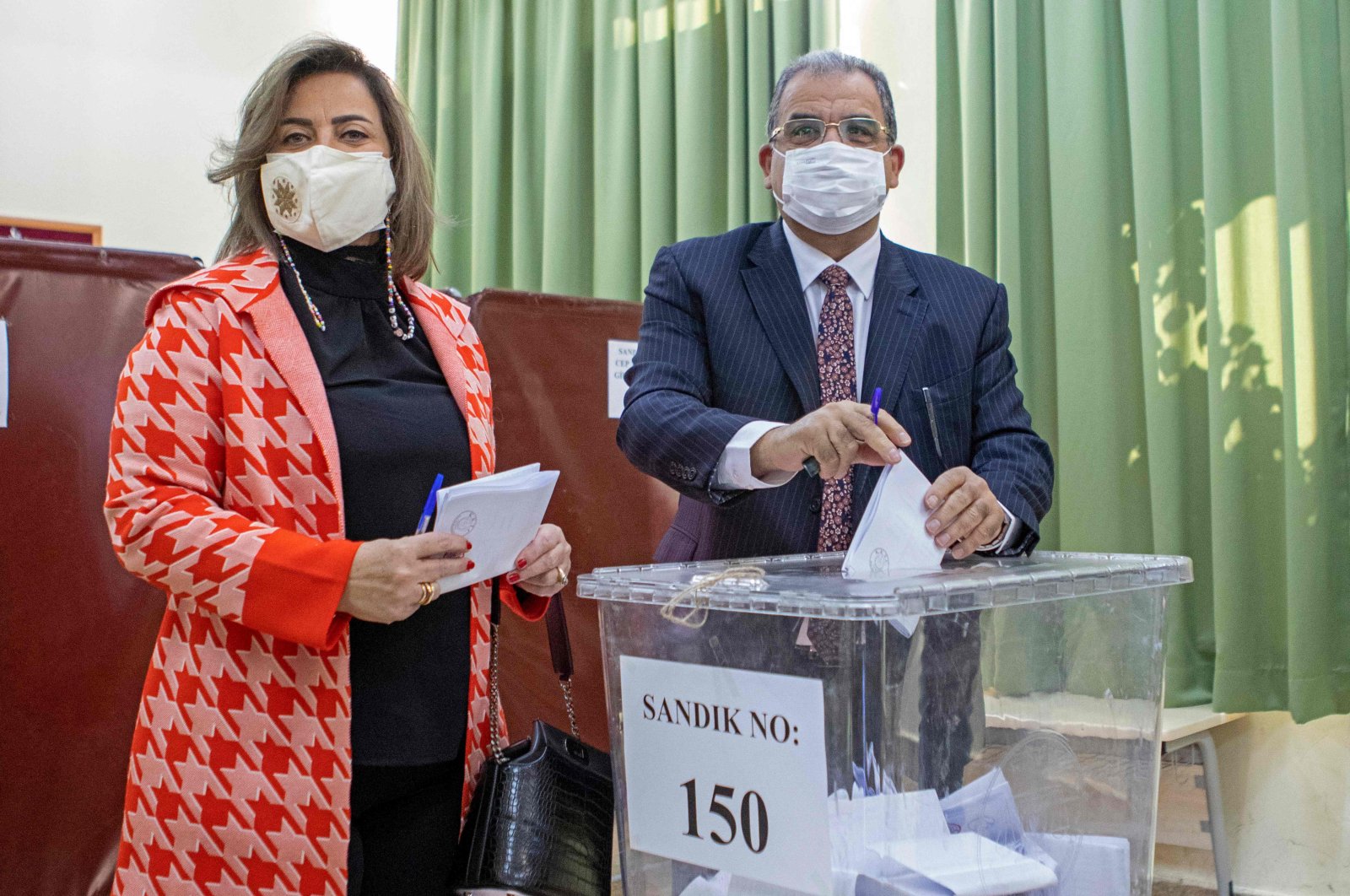 Prime Minister Faiz Sucuoğlu alongside his wife casts his ballot at a polling station in the capital Lefkoşa (Nicosia), TRNC, Jan. 23, 2022. (AFP Photo)