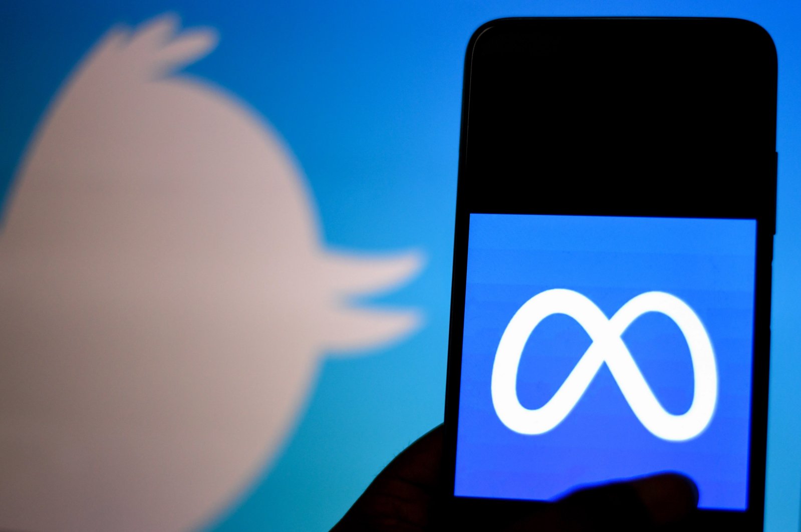 In this photo illustration a metaverse logo is seen on a smartphone with a Twitter logo in the background. (Reuters Photo)