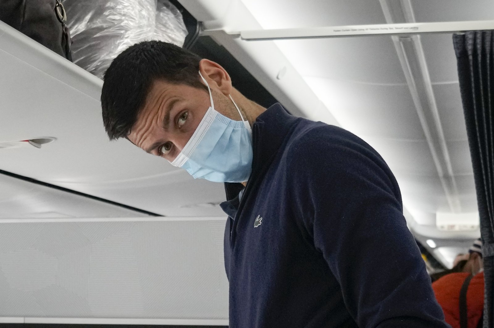 Novak Djokovic is seen onboard a plane to Belgrade, Dubai, UAE, Jan. 17, 2022. (AP Photo)