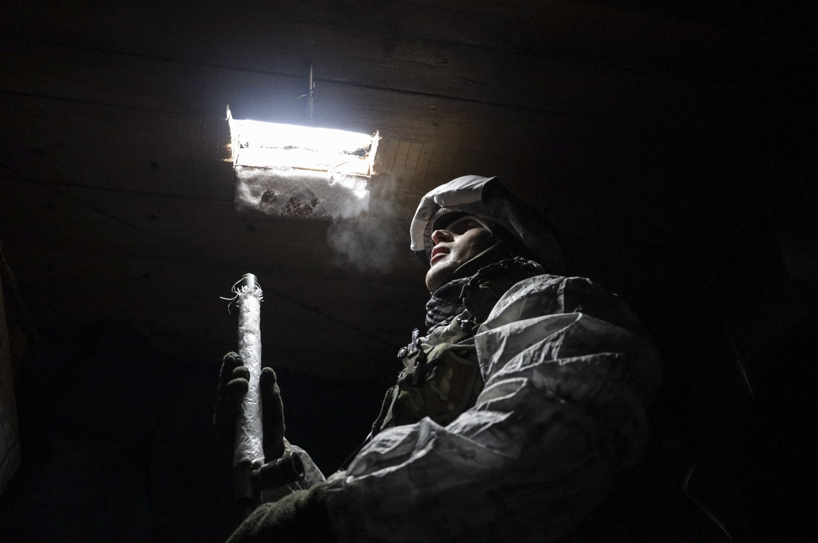 A Ukrainian officer inspects the situation on a front line near the village of Avdiivka, Ukraine, Jan. 25, 2022. (EPA Photo) 