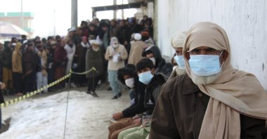 Afghans wait to receive food rations organized by the World Food Programme (WFP) in Pul-e-Alam, the capital of Logar province, eastern of Afghanistan, Jan. 18, 2022. (AP Photo)
