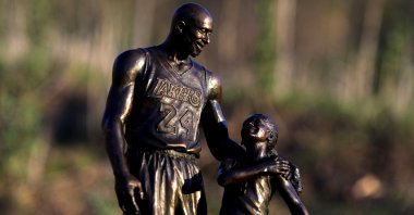 A sculpture of Kobe and Gigi Bryant by Dan Medina is seen at the helicopter crash site in Calabasas, California, U.S., Jan. 26, 2022. (Reuters Photo)
