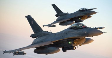 In this photo provided by Lithuanian Ministry of National Defense, Polish Air Force F-16 fighter jets participating in NATO's Baltic Air Policing Mission operate in Lithuanian airspace, Jan. 25, 2022. (AP Photo)