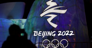 A man photographs an illuminated Beijing 2022 Winter Olympics logo, Beijing, China, Jan. 26, 2022. (Reuters Photo)