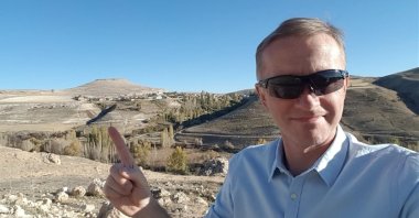 In this undated photo, Robert D. Rokicki points to the location of the ancient city of Thebasa in the Pinarkaya village of southern Karaman province, Turkey. (AA Photo)