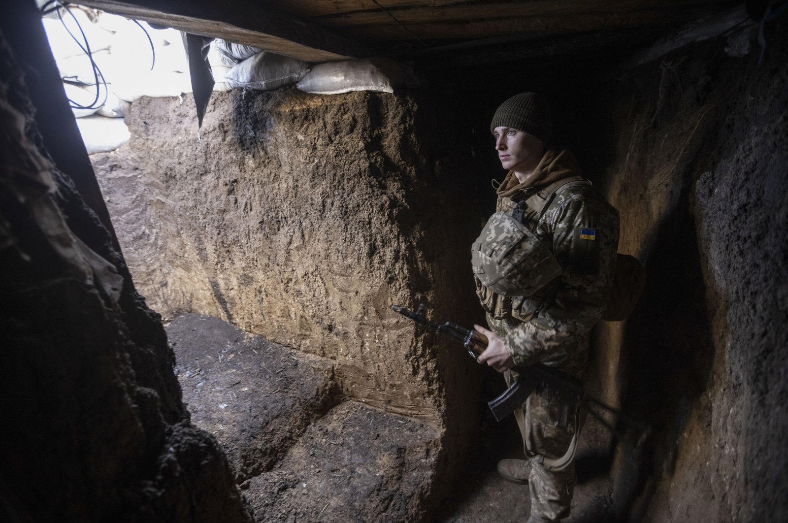An Ukrainian soldier stands in the trench on the line of separation from pro-Russian rebels, in Mariupol, Donetsk region, Ukraine, Jan. 20, 2022. (AP Photo)