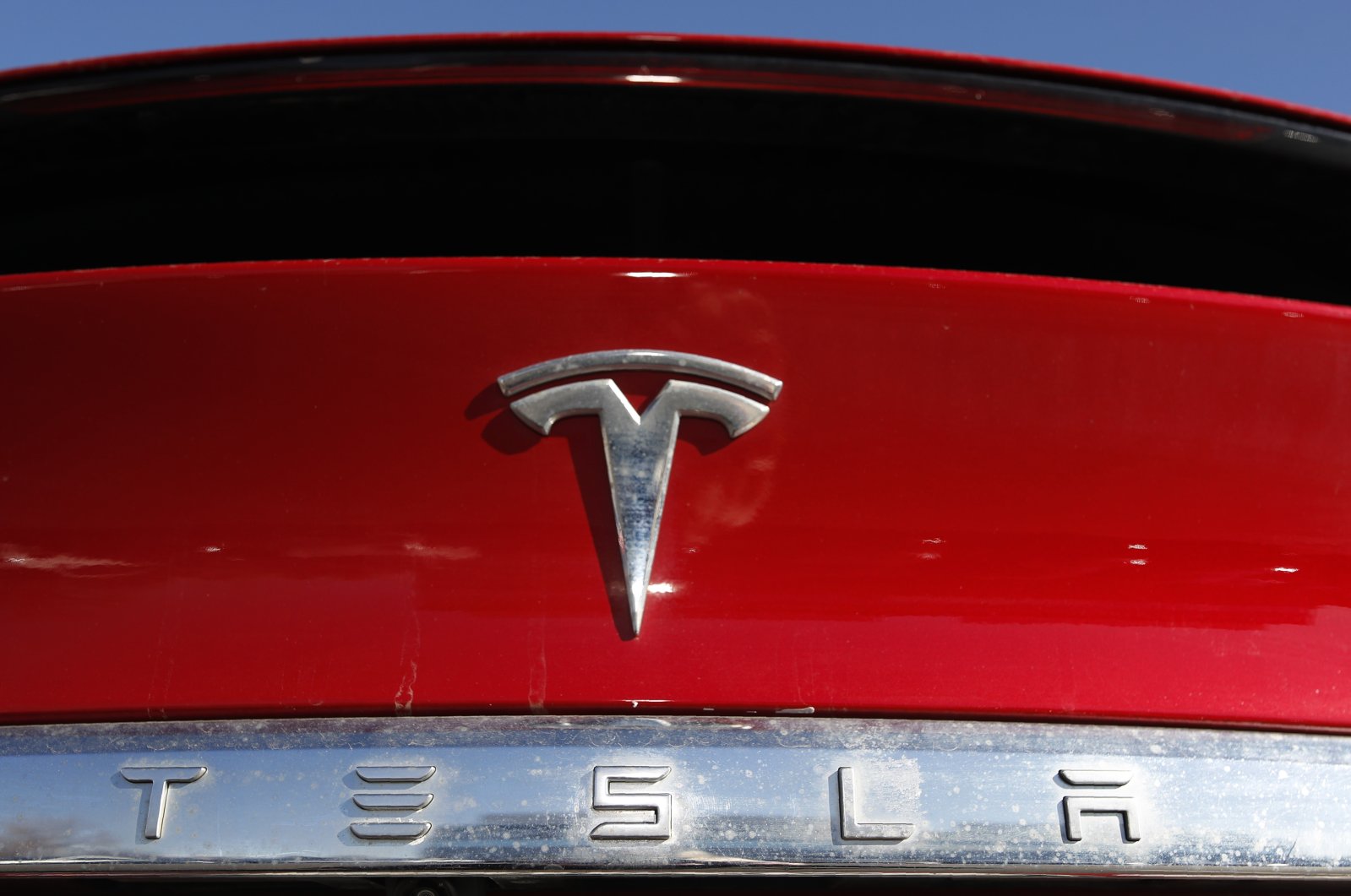 The company logo sits on an unsold 2020 Model X at a Tesla dealership in Littleton, Colorado, U.S., Feb. 2, 2020. (AP Photo)