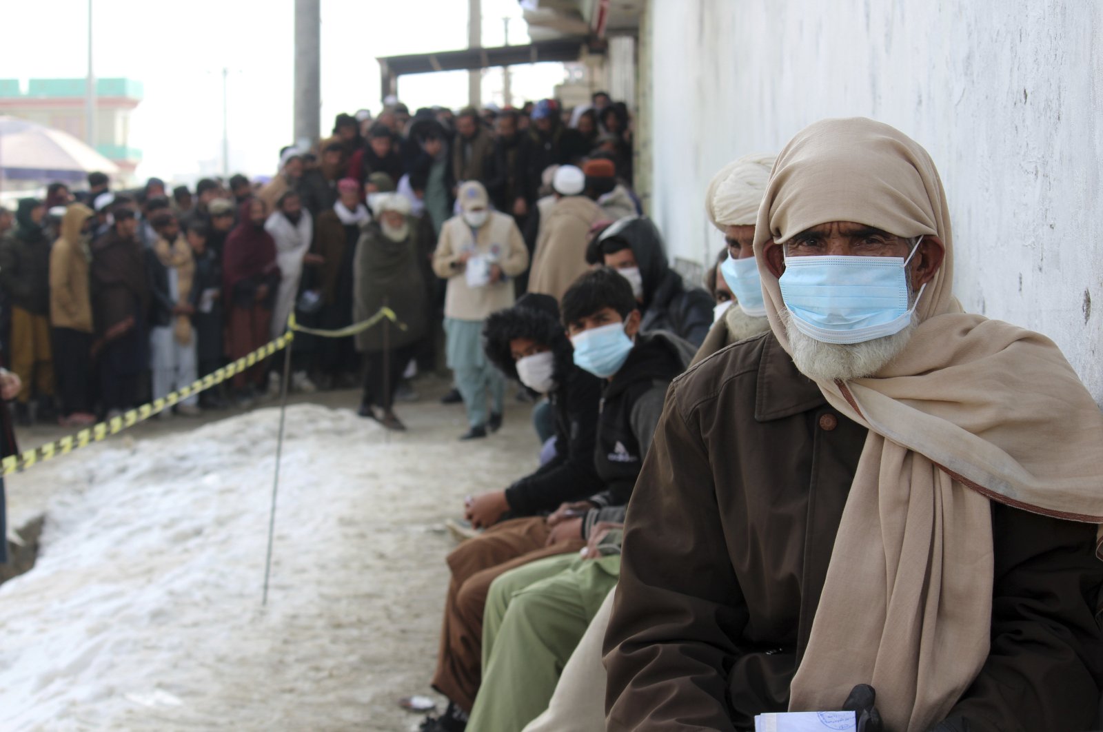 Afghans wait to receive food rations organized by the World Food Programme (WFP) in Pul-e-Alam, the capital of Logar province, eastern of Afghanistan, Jan. 18, 2022. (AP Photo)