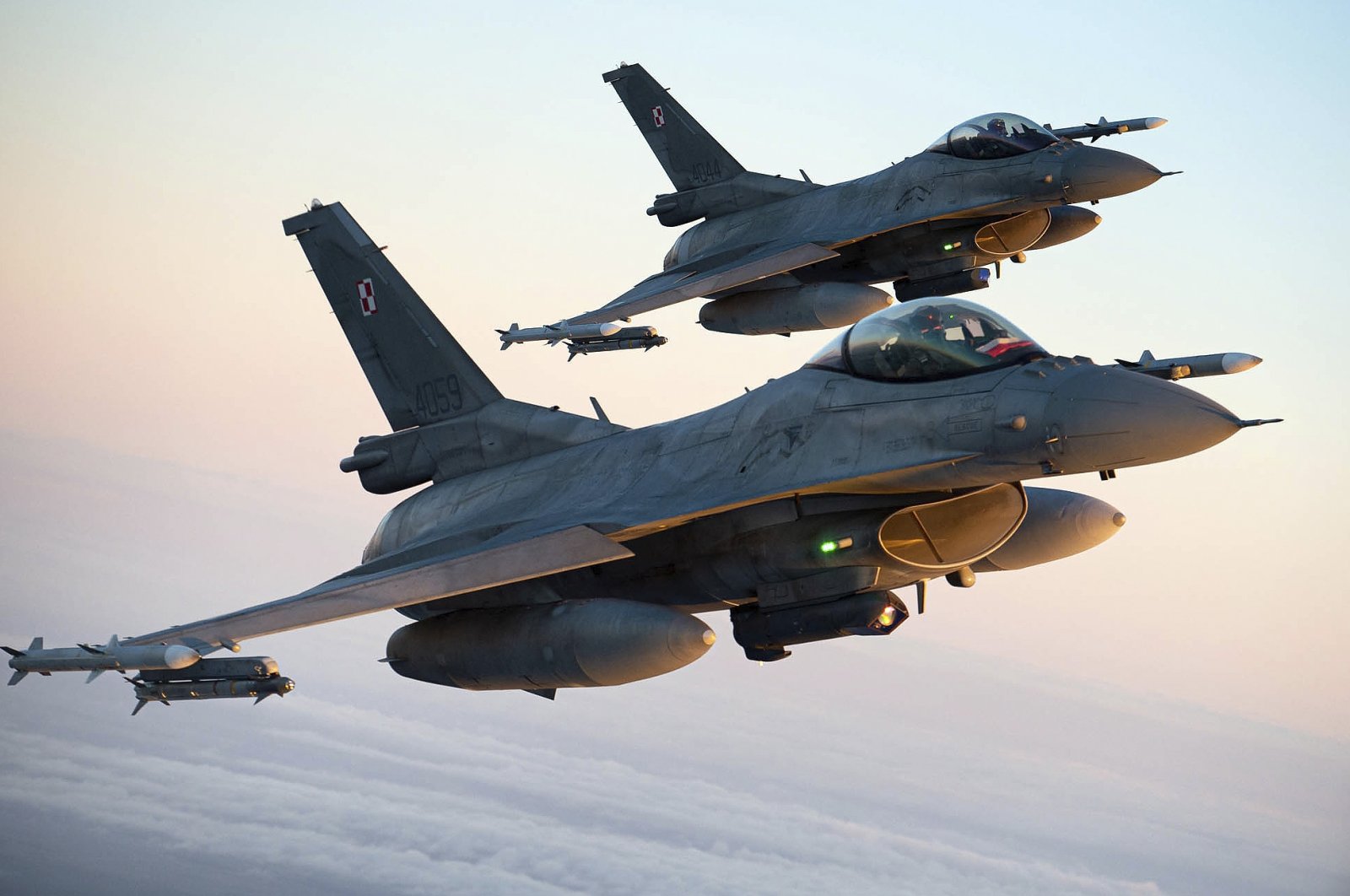 In this photo provided by Lithuanian Ministry of National Defense, Polish Air Force F-16 fighter jets participating in NATO&#039;s Baltic Air Policing Mission operate in Lithuanian airspace, Jan. 25, 2022. (AP Photo)