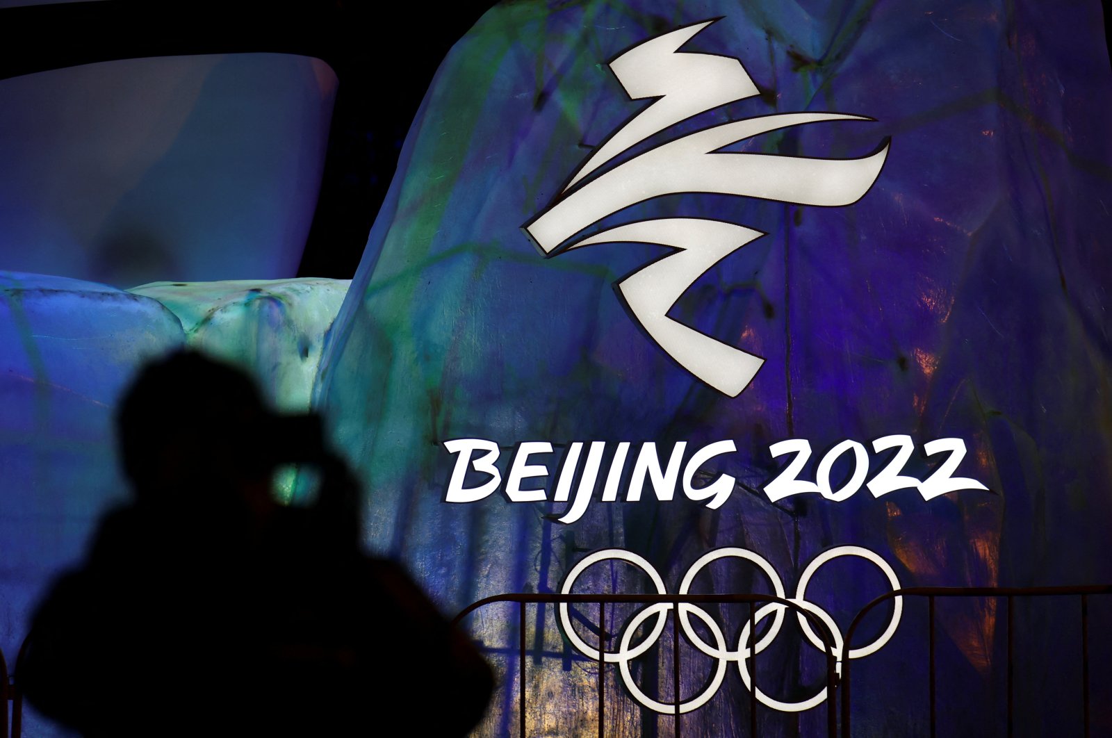 A man photographs an illuminated Beijing 2022 Winter Olympics logo, Beijing, China, Jan. 26, 2022. (Reuters Photo)