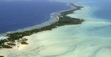 Kiribati and several other small Pacific nations were among the last on the planet to have avoided any virus outbreaks, thanks to their remote locations and strict border controls, Tarawa atoll, Kiribati, March 30, 2004. (AP Photo)