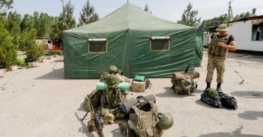A Kyrgyz border guard smokes outside a temporary camp near a frontier border post in the village of Maksat in Batken province, Kyrgyzstan, May 4, 2021. (Reuters Photo)