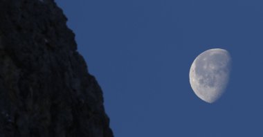 The moon shines over the course of an alpine ski race in Cortina d'Ampezzo, Italy, Jan. 23, 2022. (AP Photo)