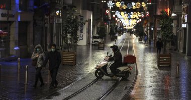 A courier on Istiklal street, the main shopping street in Istanbul, minutes into the lockdown, Istanbul, Turkey, Nov. 21, 2020. (AP Photo)