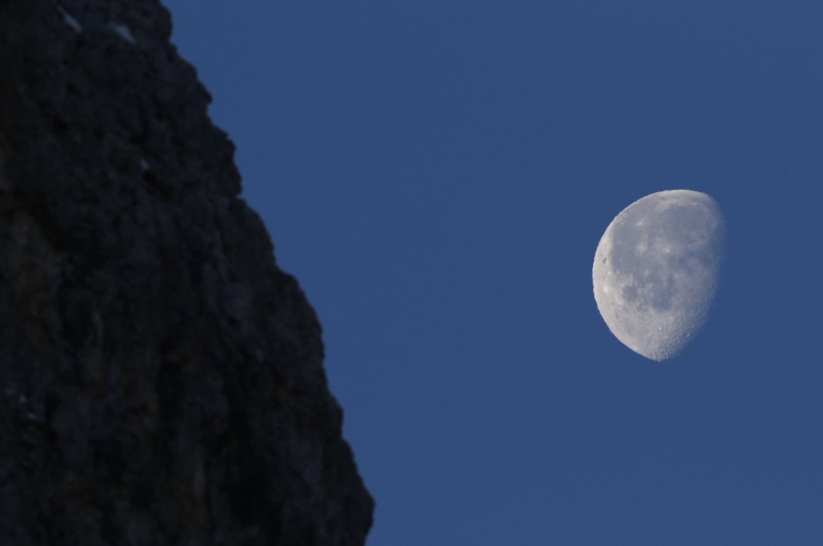The moon shines over the course of an alpine ski race in Cortina d&#039;Ampezzo, Italy, Jan. 23, 2022. (AP Photo)