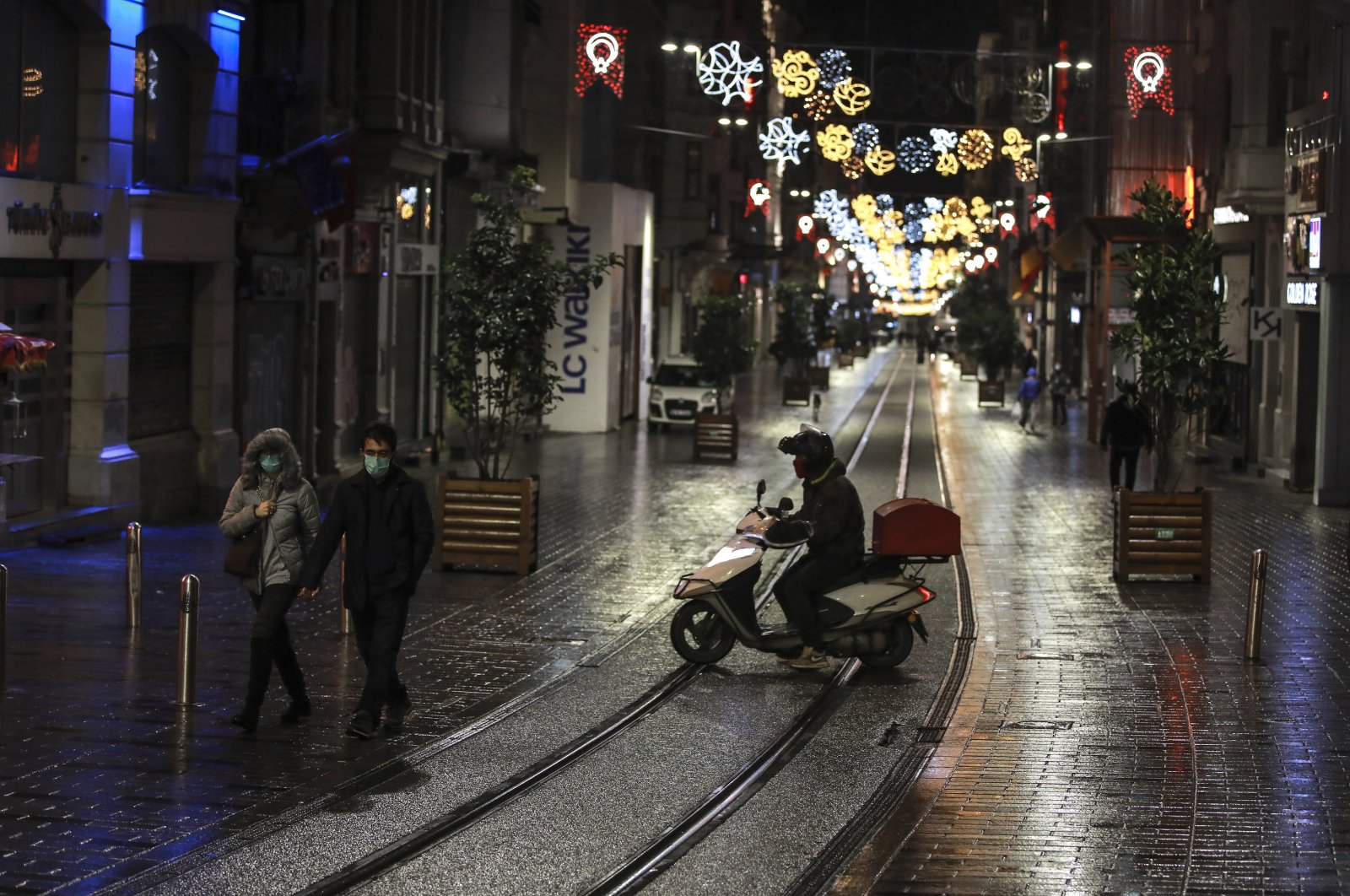 A courier on Istiklal street, the main shopping street in Istanbul, minutes into the lockdown, Istanbul, Turkey, Nov. 21, 2020. (AP Photo)