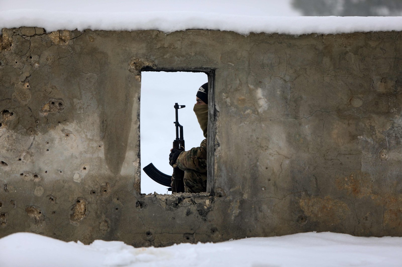 A Turkey-backed Syrian fighter is pictured during military training at a snow-covered base in the Afrin region in the northwestern Aleppo province, Syria, Jan. 26, 2022. (AFP Photo)