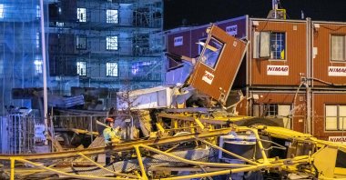 An overturned crane has crushed several construction sheds in central Malmo when storm Malik continues to ravage in the Scania area, Sweden, Jan. 30, 2022. (TT NEWS AGENCY via AFP)