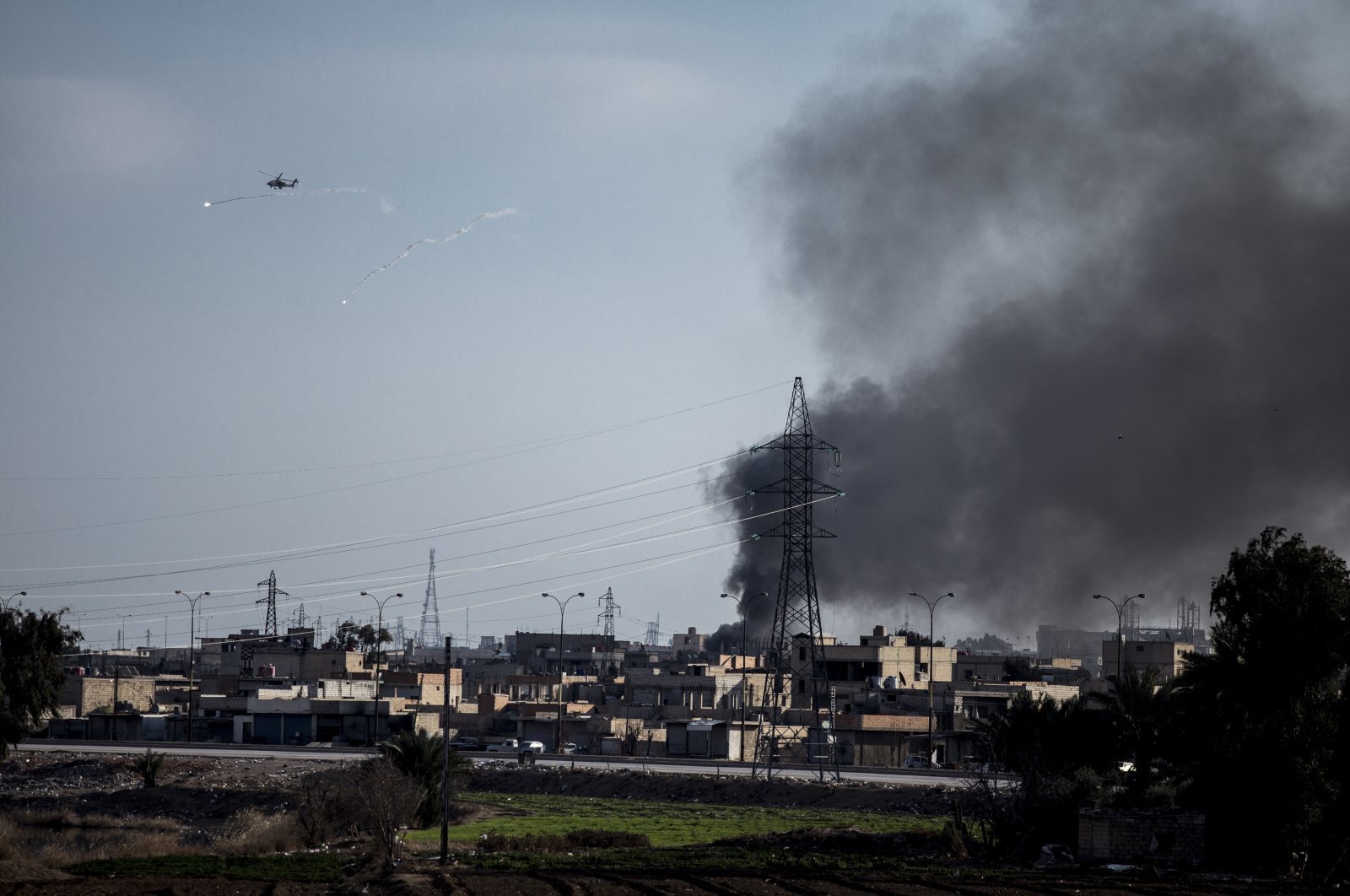 A U.S. attack helicopter shoots flares in Hassakeh, northeast Syria, Jan. 26, 2022. (AP Photo)