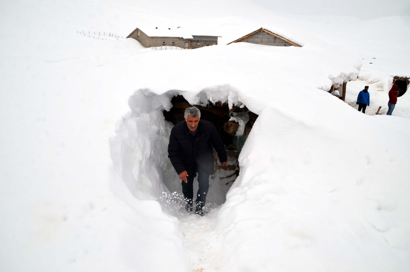 A man walks through a tunnel the villagers dug between houses under snow, in Muş, eastern Turkey, Jan. 30, 2022. (AA PHOTO) 