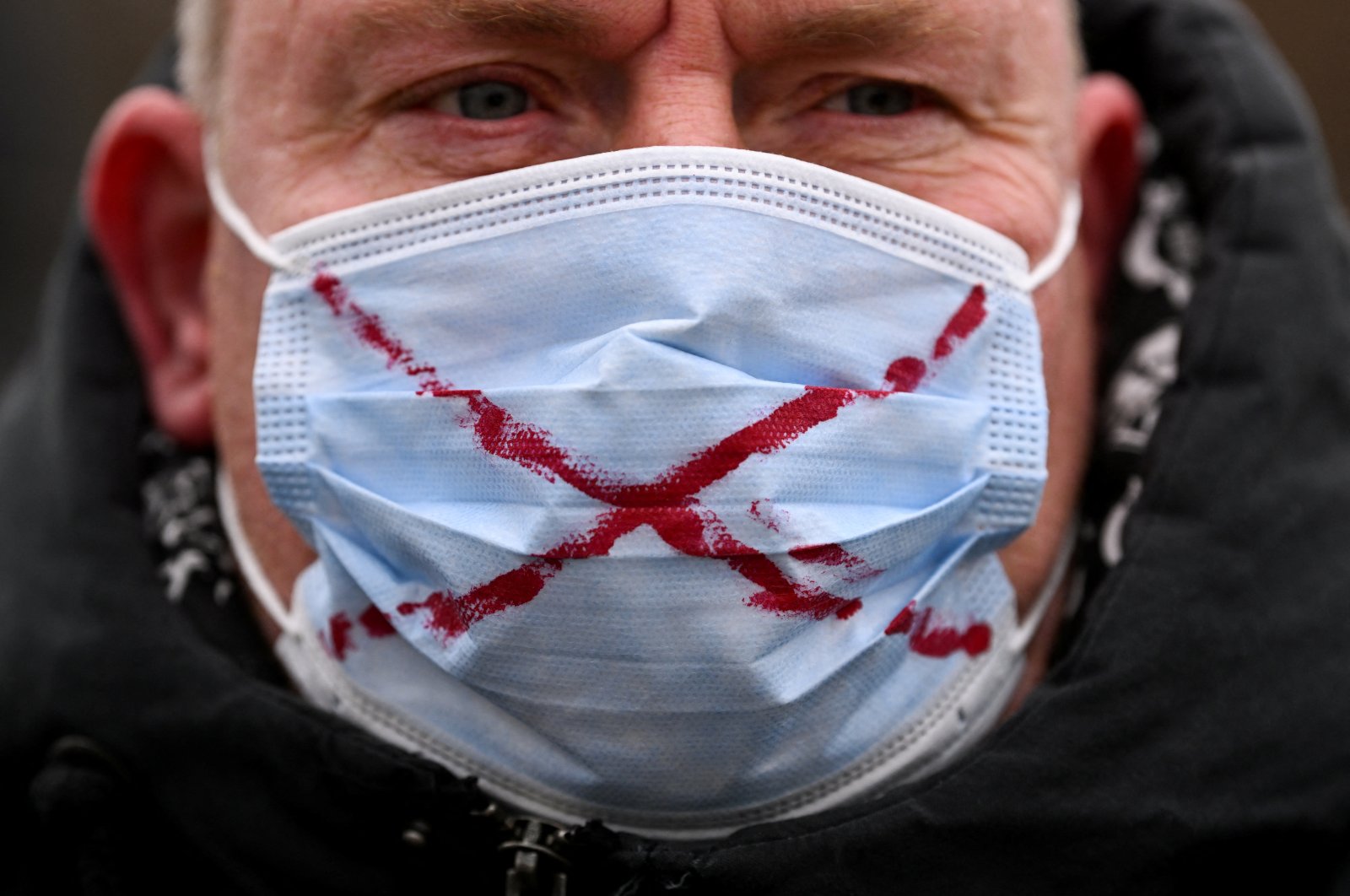 A protester wearing a face mask with a cross takes part in a protest against government measures to curb the spread of the coronavirus disease in Nuremberg, Germany, Jan. 30, 2022. (Reuters Photo)