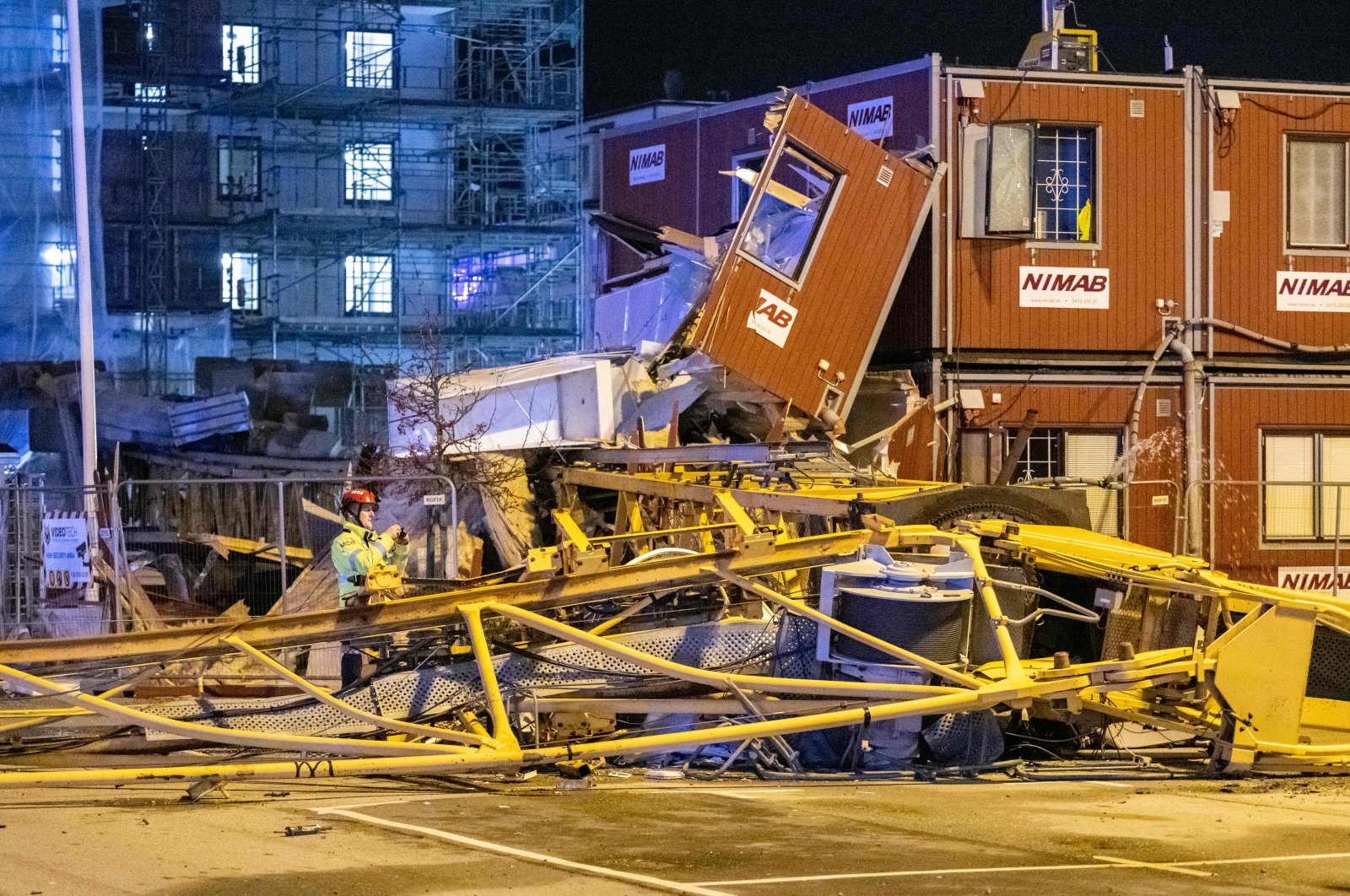 An overturned crane has crushed several construction sheds in central Malmo when storm Malik continues to ravage in the Scania area, Sweden, Jan. 30, 2022. (TT NEWS AGENCY via AFP)