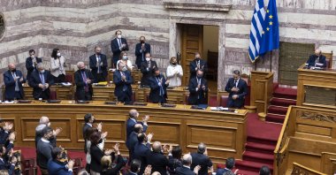 Greek Prime Minister Kyriakos Mitsotakis is applauded by his party's deputies during a parliament session in Athens, Greece, Jan. 30, 2022. (AP Photo)