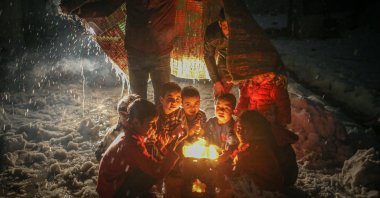 Children are seen burning clothes to keep warm in Idlib, northwestern Syria, Jan. 31, 2022. (AA Photo)