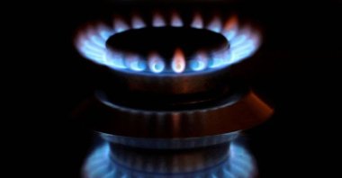 Flames from a gas burner are reflected on a cooker in a private home in Bad Honnef near Bonn, Germany, Oct. 11, 2021. (Reuters Photo)
