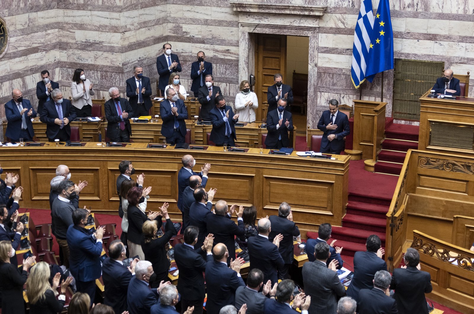 Greek Prime Minister Kyriakos Mitsotakis is applauded by his party&#039;s deputies during a parliament session in Athens, Greece, Jan. 30, 2022. (AP Photo)