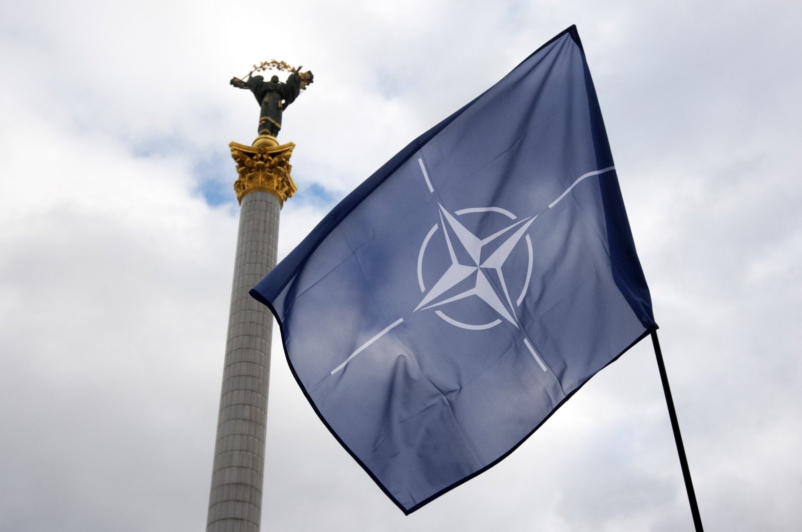 The NATO flag flies in front of the Independence Monument in Kyiv, Ukraine, Jan. 30, 2022. (Reuters Photo)