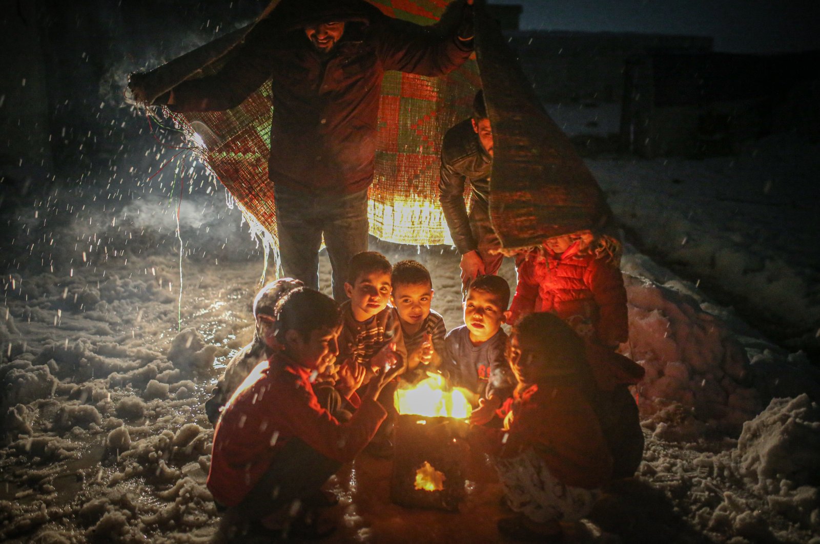 Children are seen burning clothes to keep warm in Idlib, northwestern Syria, Jan. 31, 2022. (AA Photo)