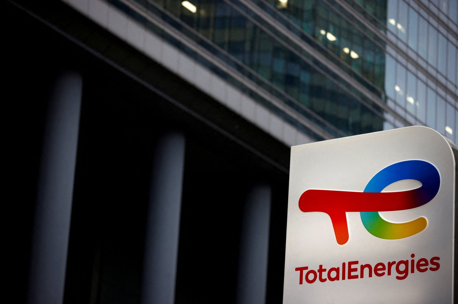 The logo of French oil and gas company TotalEnergies is pictured at an electric car charging station and petrol station at the financial and business district of La Defense in Courbevoie near Paris, France, June 22, 2021. (Reuters Photo)